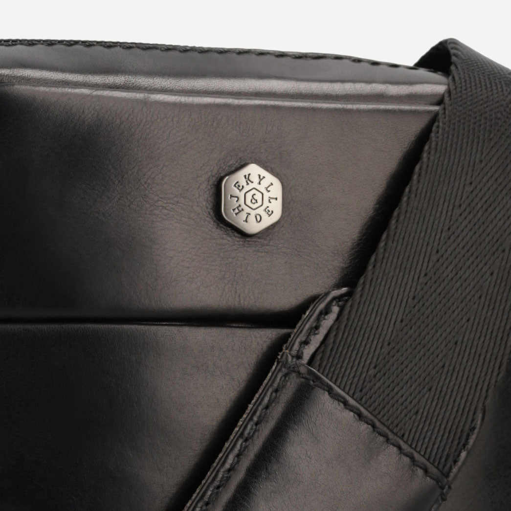 Close-up detail of the Jekyll and Hide - Small Crossbody Organiser - Mocha | Tan | Black in black leather.