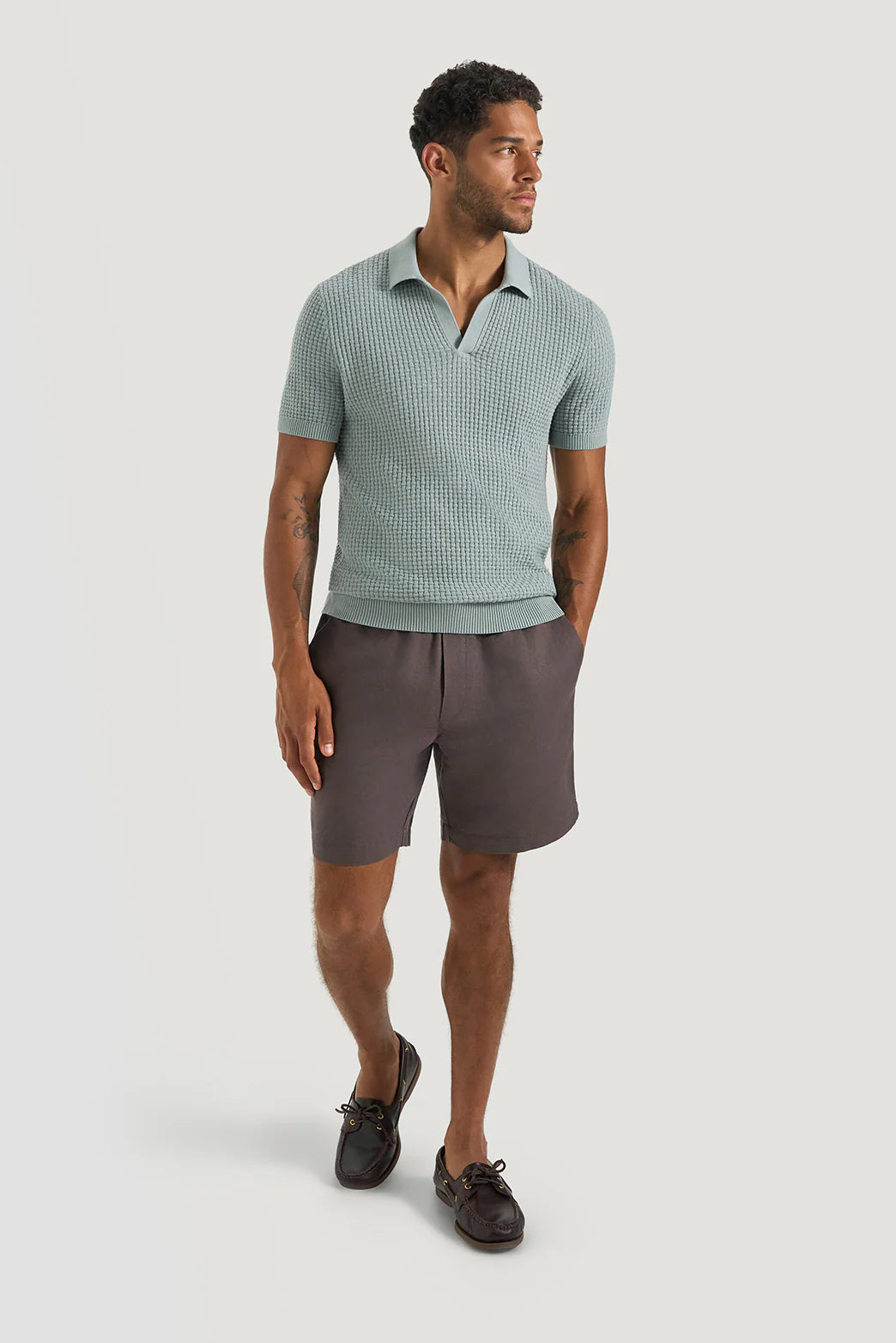 M.J. Bale - Byron Linen Blend Short - Brown worn by a model with a light blue short-sleeve polo and casual shoes.