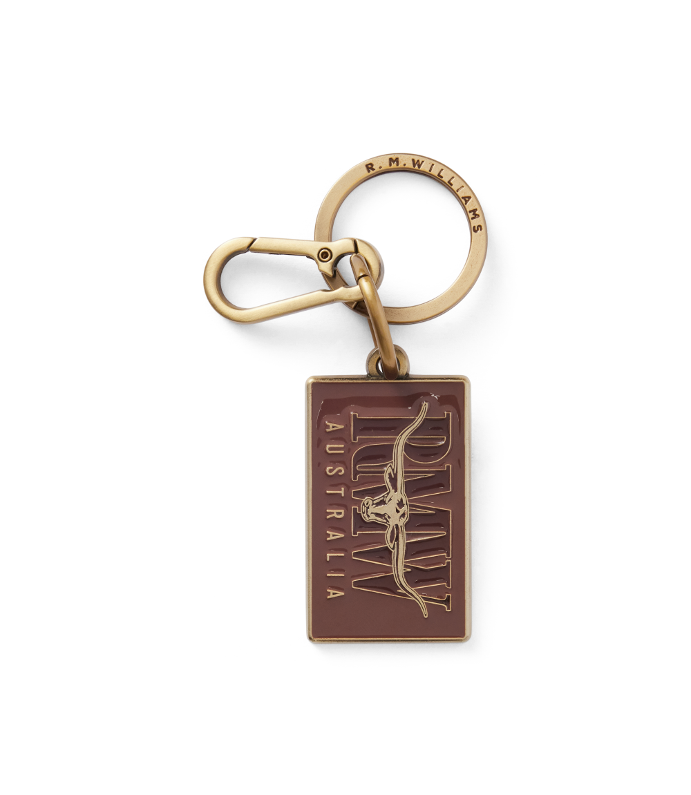 R.M.Williams - Heritage Logo Enamel Keyring - Chestnut with brass hardware and spring-loaded snap hook.