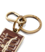 R.M.Williams - Heritage Logo Enamel Keyring - Chestnut with brass hardware and spring-loaded snap hook.