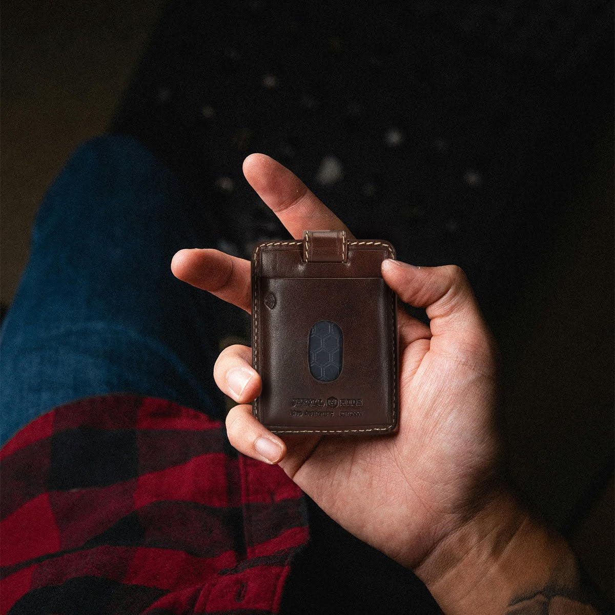 Jekyll and Hide - Compact Tab Card Holder - Black | Mocha | Tan held in a hand, showcasing its sleek design and RFID protection.