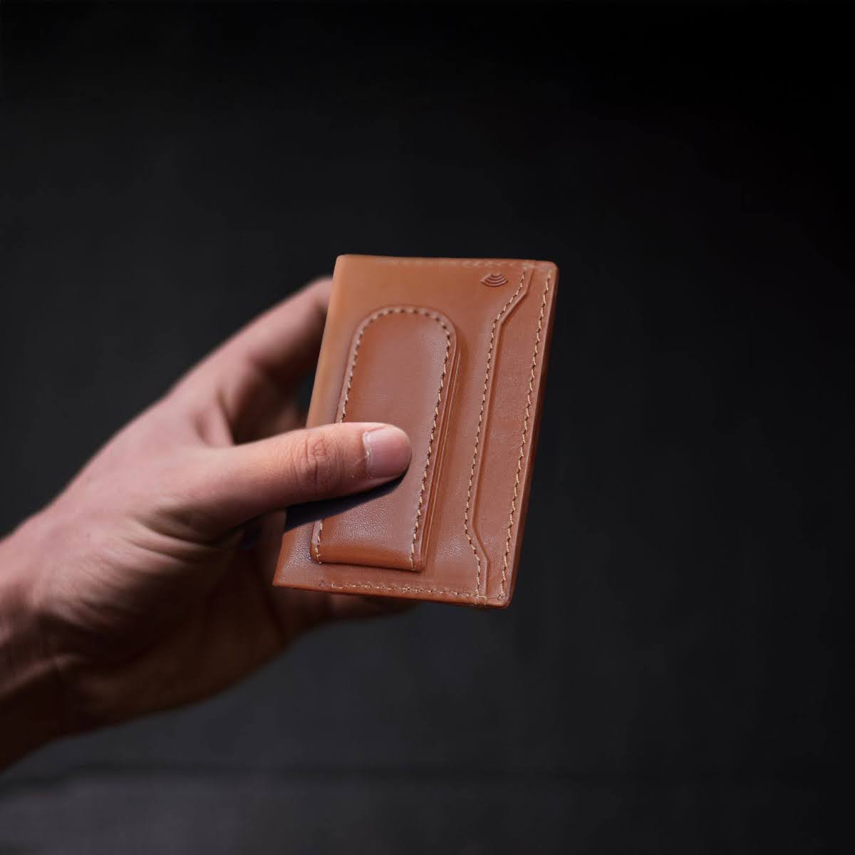 Jekyll and Hide - Money Clip Card Holder - Black | Mocha | Tan held in hand, showcasing its sleek design and vegetable-tanned leather.
