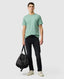 Rodd & Gunn - The Gunn T-Shirt 2.0 - Dusty Sage - MULTIBUY worn by a model with a bag.