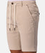 Beige drawstring shorts with a button closure, belt loops, and side pockets, shown on a model against a light gray background.
