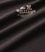 Close-up of a dark brown textured fabric with a light beige embroidered logo reading 'R.M.Williams