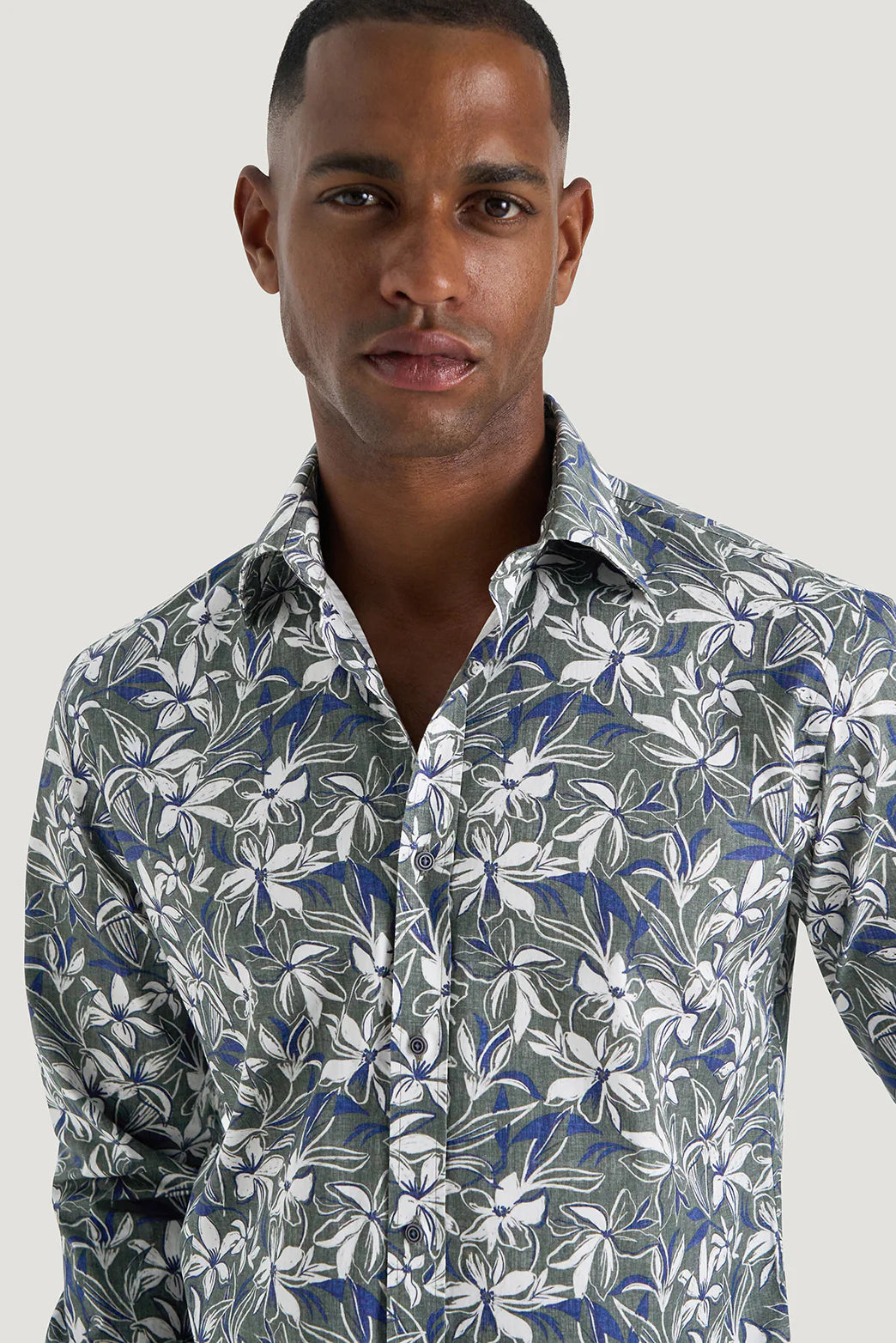 M.J. Bale - Marcello Floral Shirt - Green Navy & White - MULTIBUY worn by a model, showcasing its seasonal floral print.