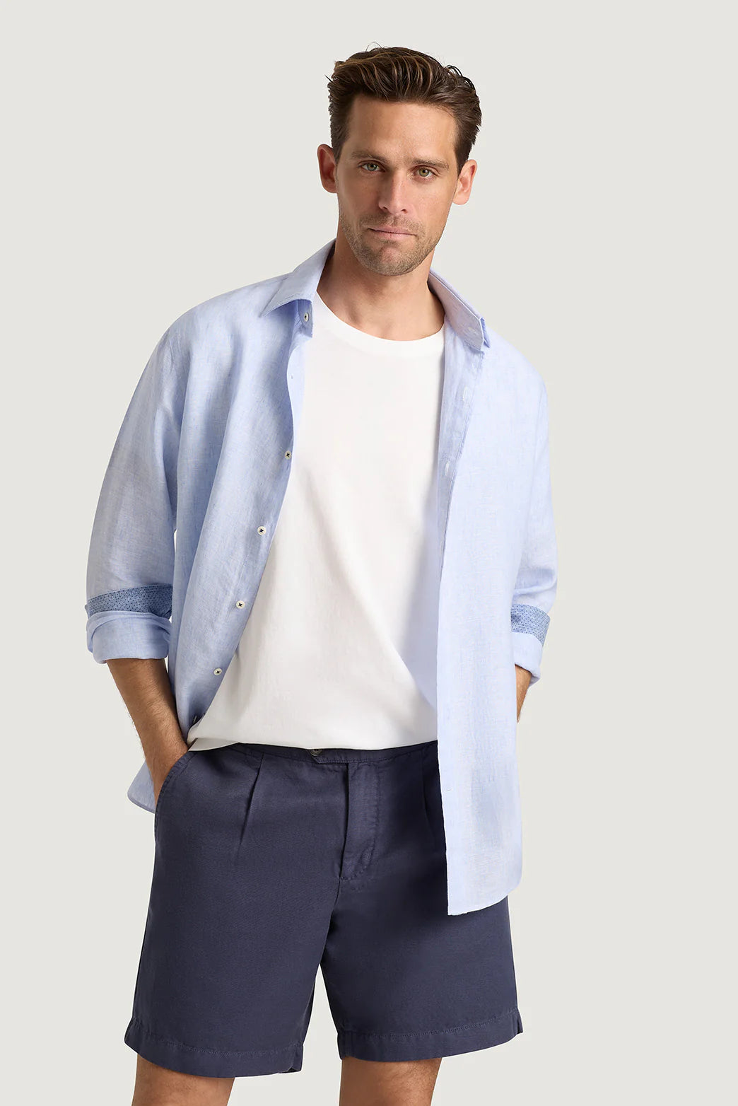 M.J. Bale - Menorca Side Tab Short- Denim modeled with a light blue shirt and white tee, showcasing casual summer style.