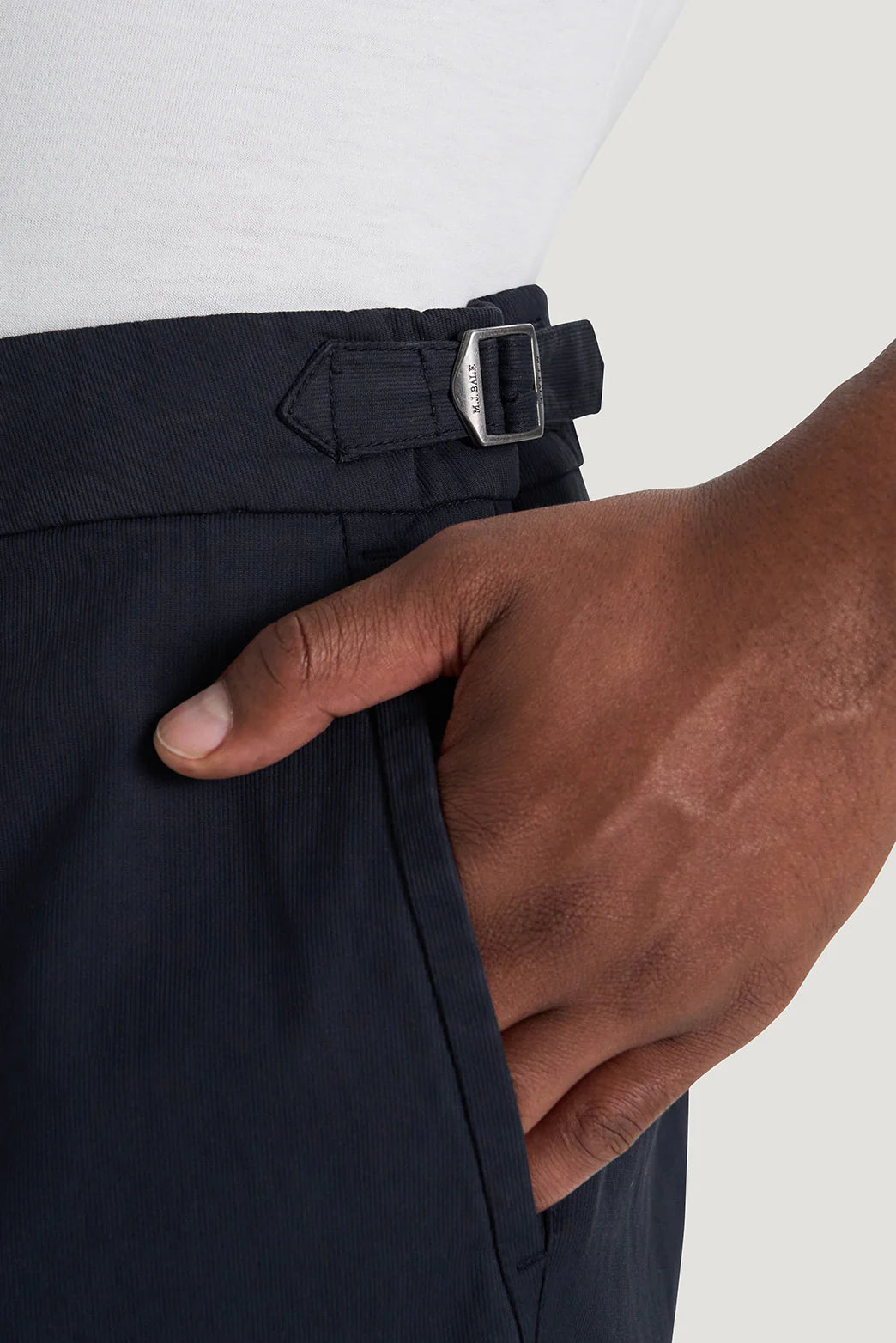 M.J. Bale - Rhode Trouser - Navy showcasing side tab with metal adjuster and hand in pocket detail.
