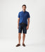 R.M.Williams - Nicholson Denim Short - Indigo showcased on a model wearing a blue polo and brown boat shoes.