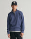 GANT - Sacker Rib Half-Zip Sweatshirt - Dark Jeans-Blue Melange worn by a model, featuring half-zip collar and tonal logo.