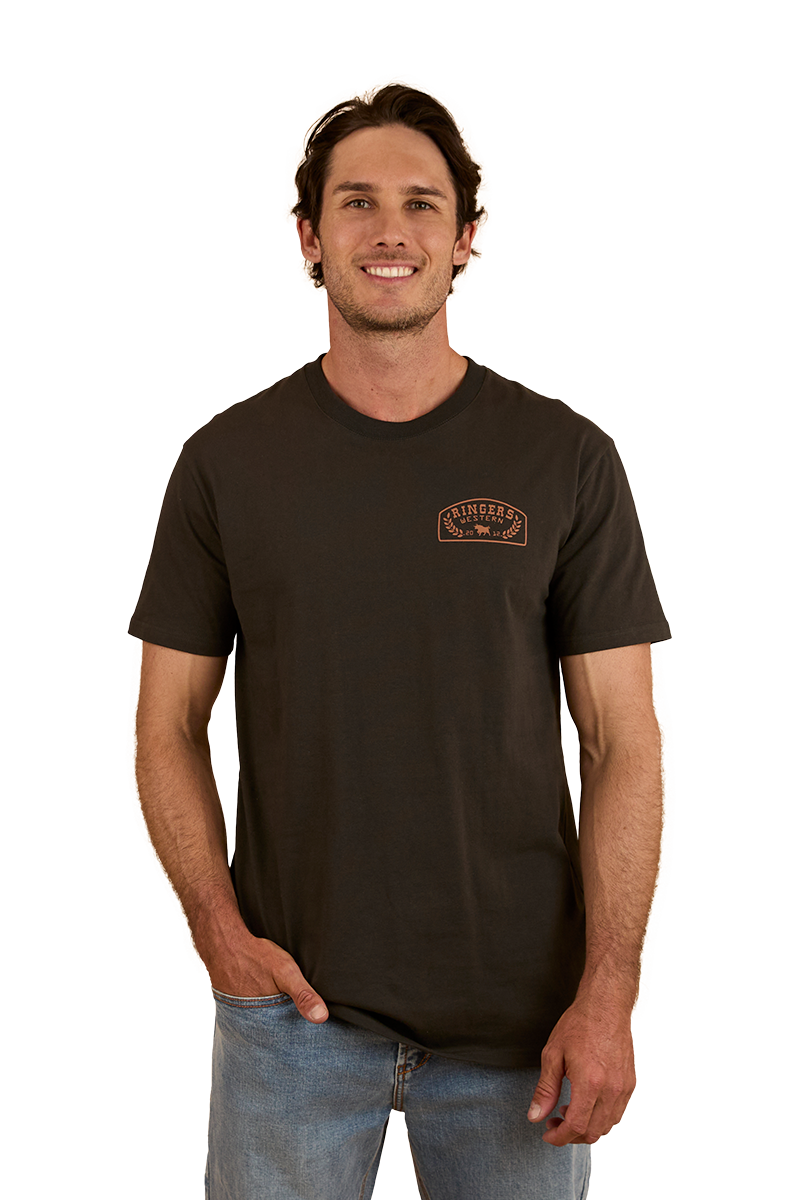 Ringers Western - Wheatbelt Stock Fit T-Shirt- Charcoal/Copper worn by a man, showcasing its casual style and comfort.