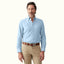 How to Wear Polo Button-Down Shirts for a Smart-Casual Look: A man in a light blue button-down shirt styled for smart-casual elegance.