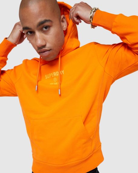 Superdry - Fusing Vintage Americana & Japanese-inspired Graphics with a British Style, model wearing orange hoodie.