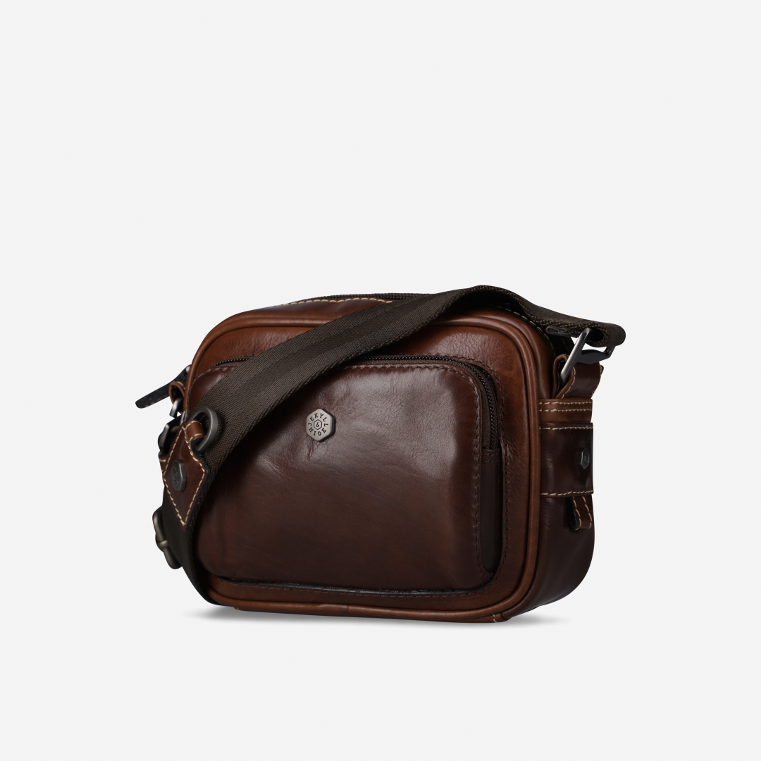 Jekyll and Hide - Small Travel Crossbody Bag - Mocha displayed in mocha leather with adjustable strap and zip compartments.