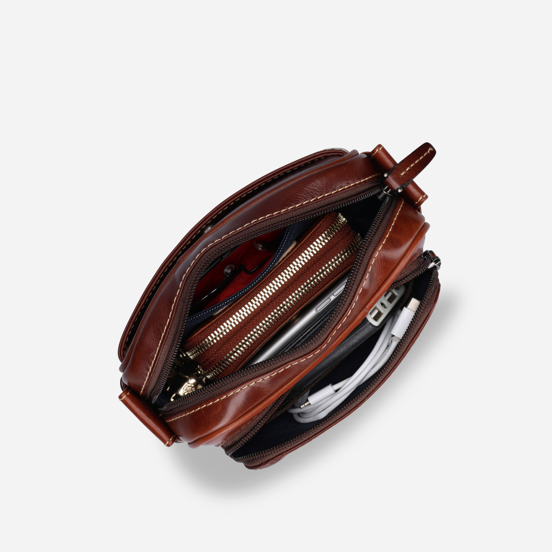 Jekyll and Hide - Small Travel Crossbody Bag - Mocha with organized compartments showcasing zip pockets and accessories inside.