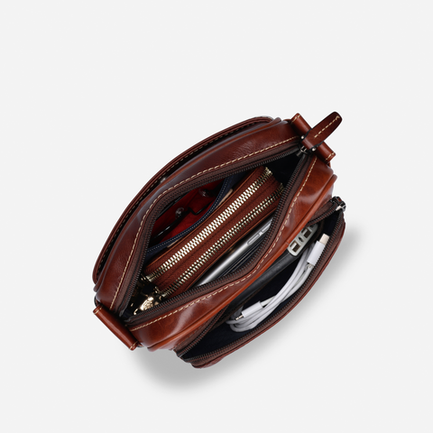 Jekyll and Hide - Small Travel Crossbody Bag - Mocha with organized compartments showcasing zip pockets and accessories inside.