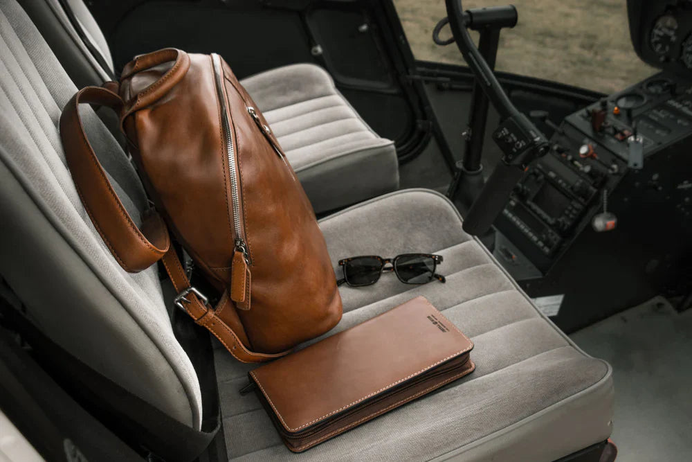 Jekyll and Hide - Large Zip-Around Travel And Passport Organiser - Tan | Mocha | Black on a helicopter seat.