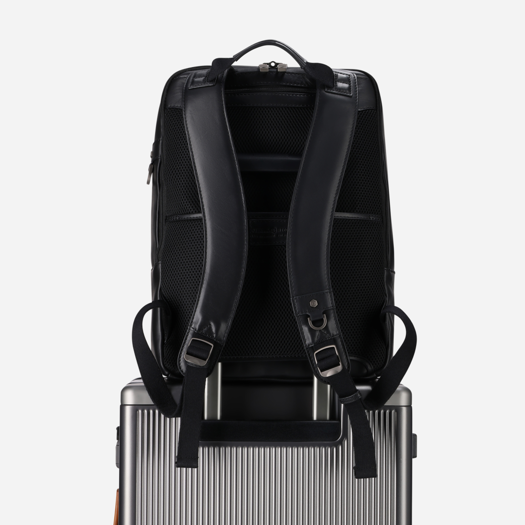 Jekyll and Hide - 17" Laptop Backpack - Colt | Black on top of luggage with ergonomic straps