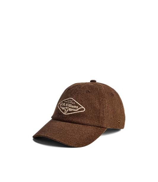 A brown washed cotton baseball cap with a curved brim, featuring a cream embroidered diamond logo on the front that reads 'The Art of Williams'.