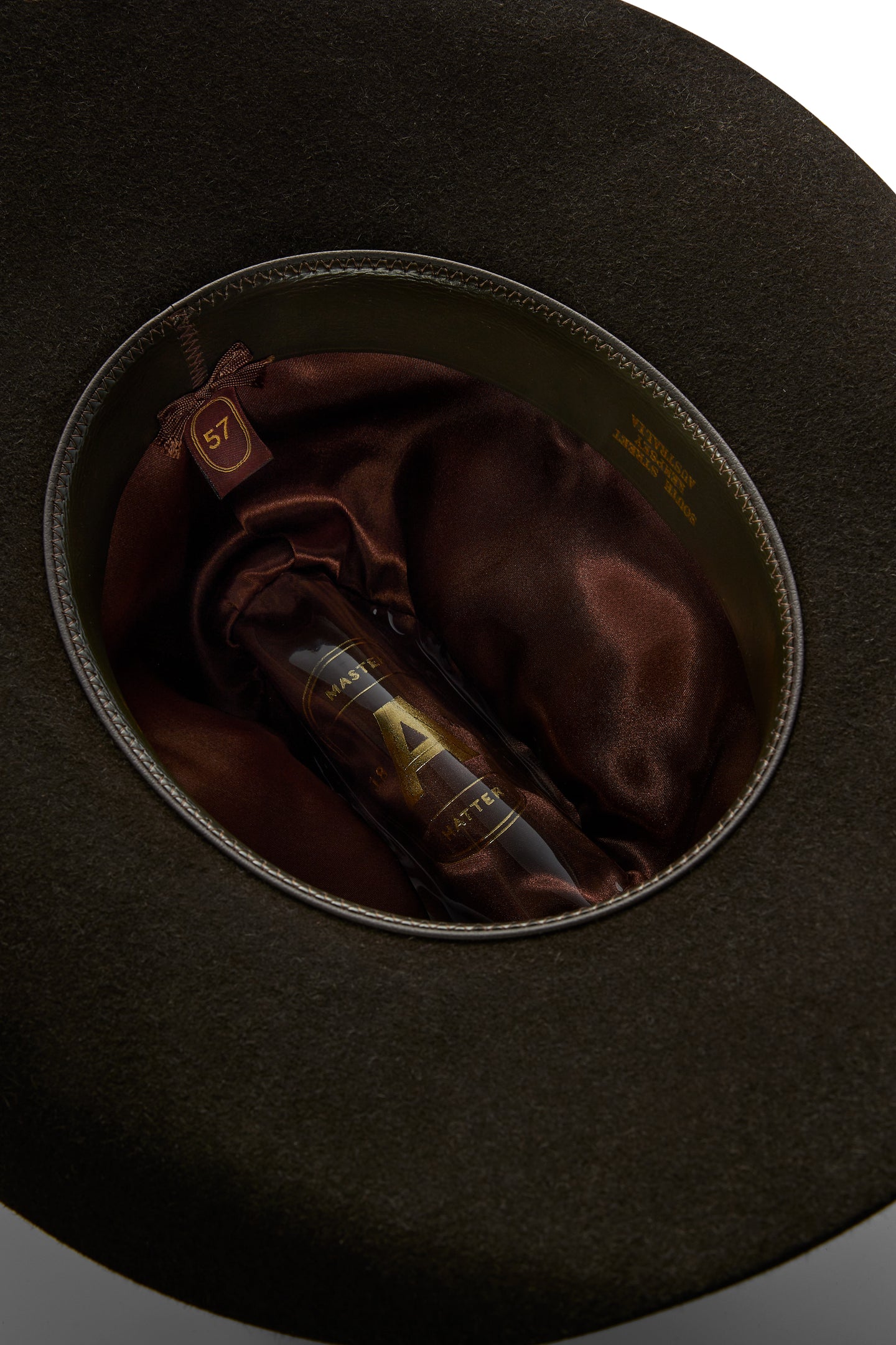 Interior view of the Akubra - Big Sky Hat - Bitter Chocolate showcasing the satin lining and size tag.