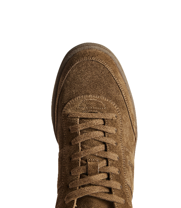 Close-up top-down view of a brown suede lace-up shoe on a plain white background.