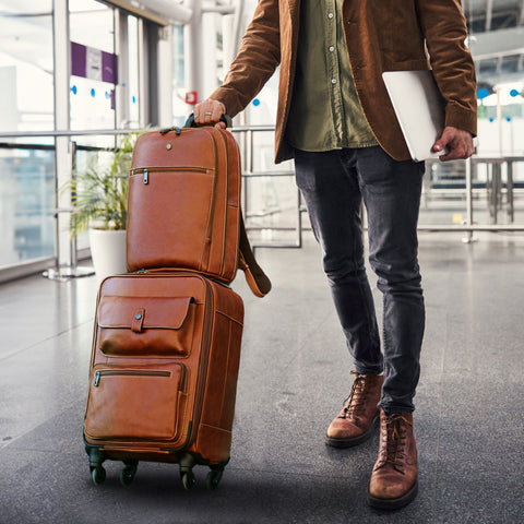 Jekyll and Hide - 4 Wheel Cabin Trolley 50cm - Colt - OVERSIZE PARCEL carried by a stylish man at the airport.