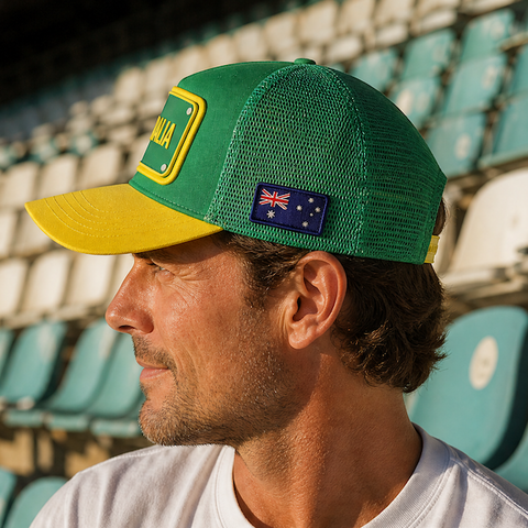 FIFA World Cup Australia Cap - Green. Man wearing a green and yellow cap with a logo in an outdoor setting.