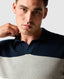 Rodd & Gunn - Brunswick Knit Polo - Teal worn by a model, showcasing its modern design and engineered striped panels.