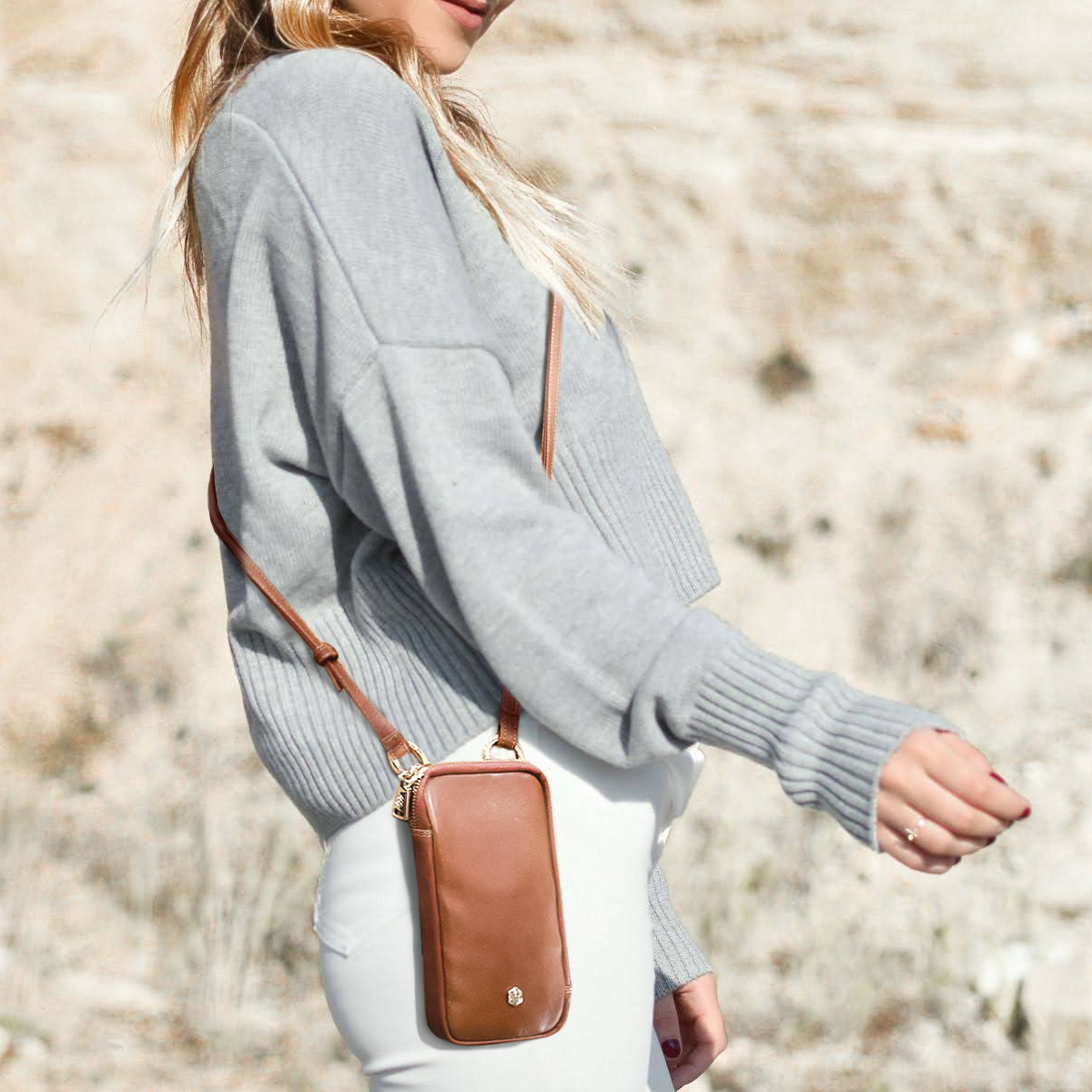 Jekyll and Hide - Mobile Phone Pouch With Strap - Black | Tan | Multiple Colours showcased by a woman in casual attire.