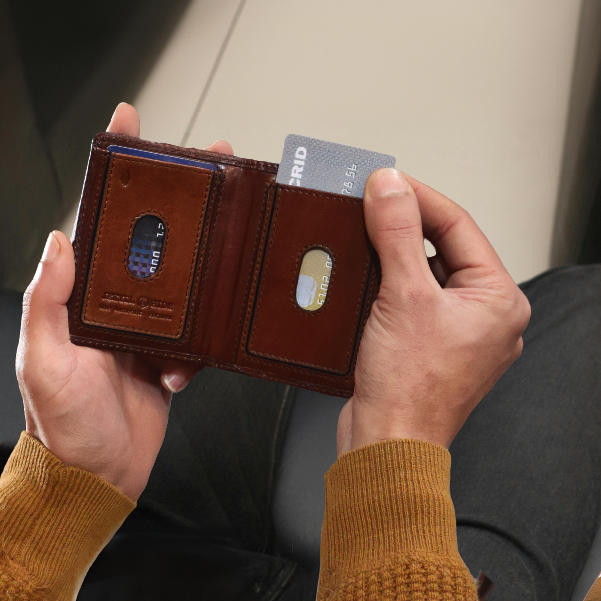 Jekyll & Hide - Slim Elasticated Card Holder - Mocha | Black | Tan showing RFID card feature in hand.