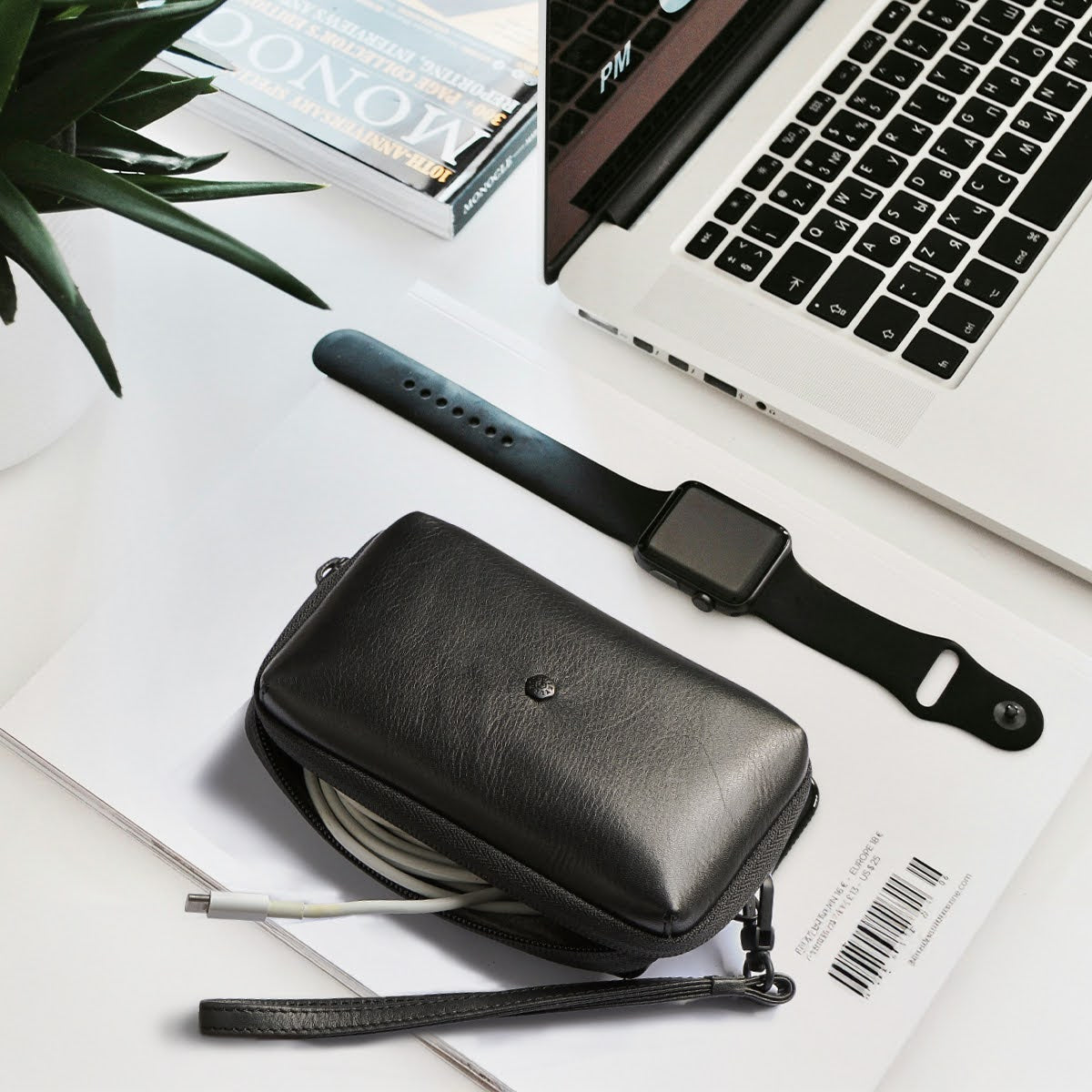 Jekyll and Hide - Compact Zip Around Cable Pouch - Tan | Black | Mocha alongside tech accessories on a desk.