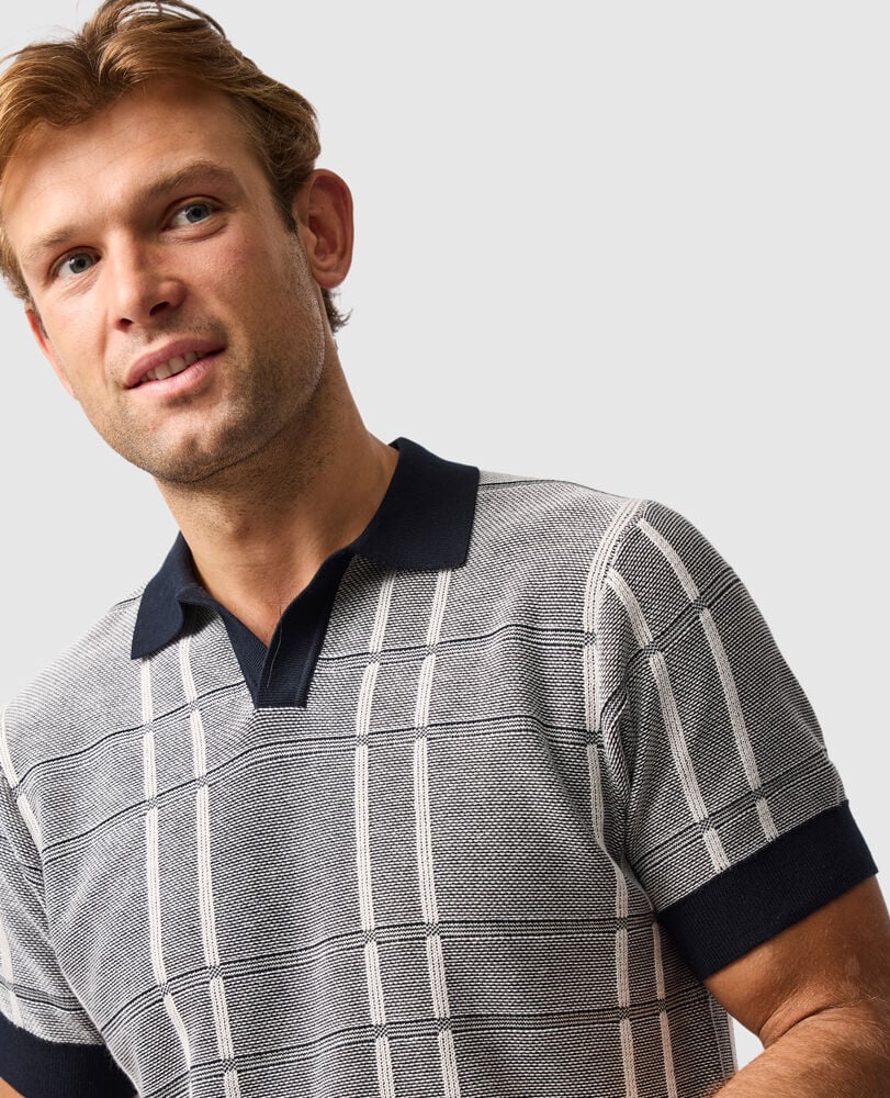 Rodd & Gunn - Dryden Bay Knit Polo - Eclipse worn by a man showcasing its stylish check jacquard design and comfortable fit.