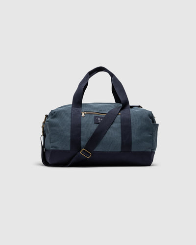 Rodd & Gunn - Foxton Duffle Bag - Denim, a durable cotton canvas travel bag with adjustable strap and pockets.