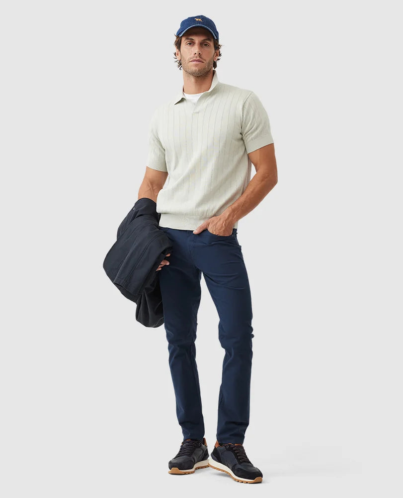 Rodd & Gunn - Freys Crescent Knit Polo - Stone worn by a model with navy pants and jacket, showcasing a casual yet stylish look.