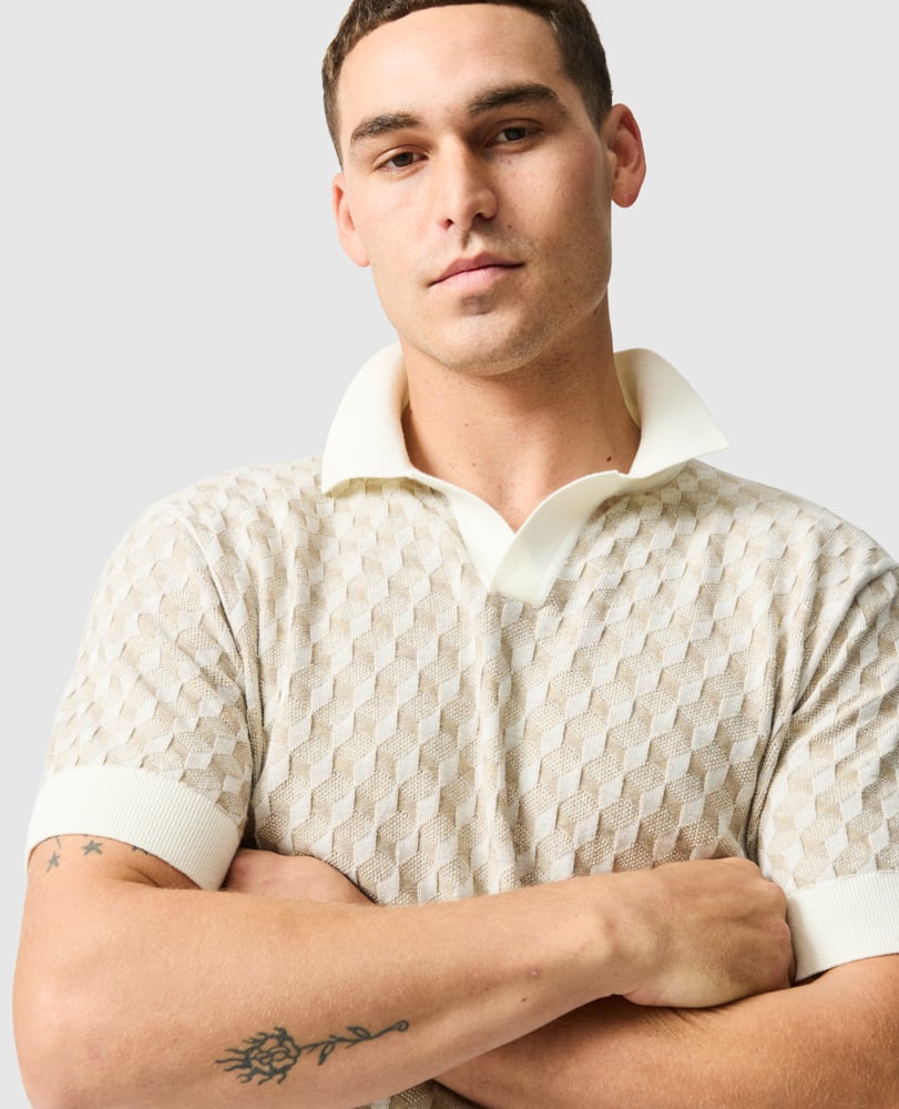Rodd & Gunn - Galdfield Knit Polo - Cream on a model, showcasing the intricate geometric stitch design and solid collar.