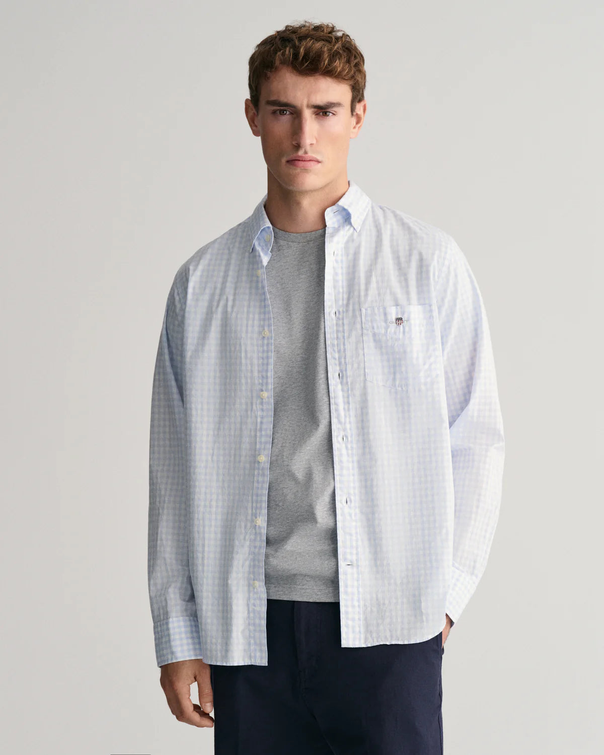 GANT - Poplin Shirt - Gingham - Light Blue & White displayed on a model wearing a casual outfit in a studio setting.