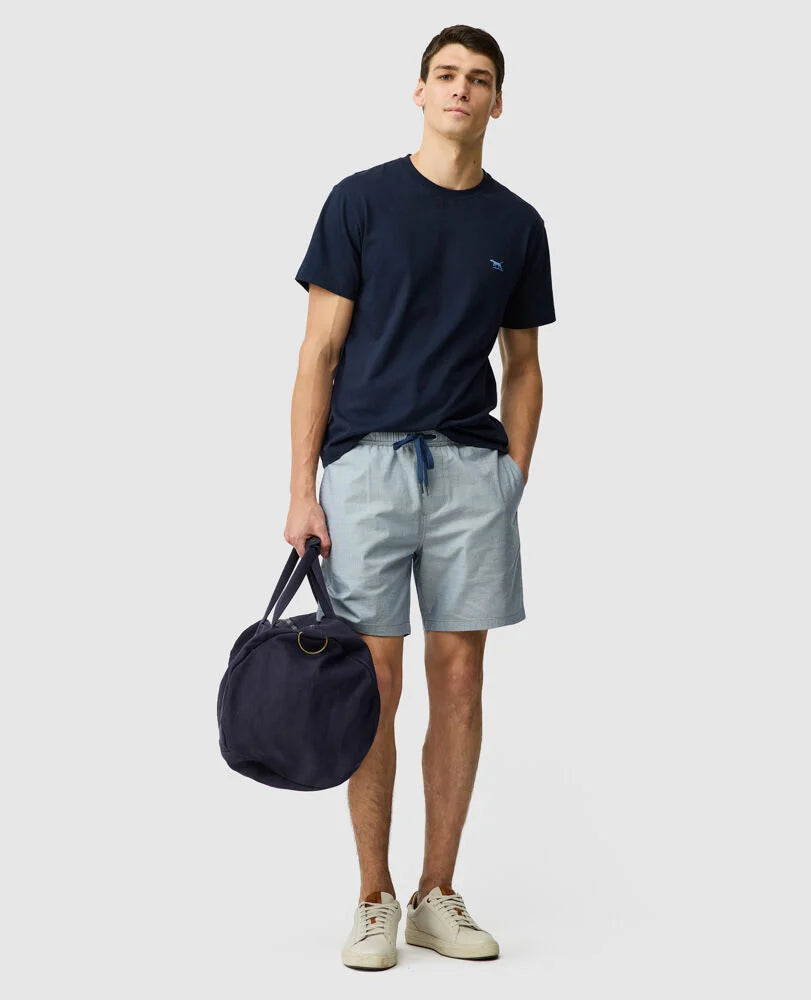 Rodd & Gunn - Gunn 7" Resort Short - Denim - MULTIBUY worn by a model with a bag, showcasing a relaxed style.