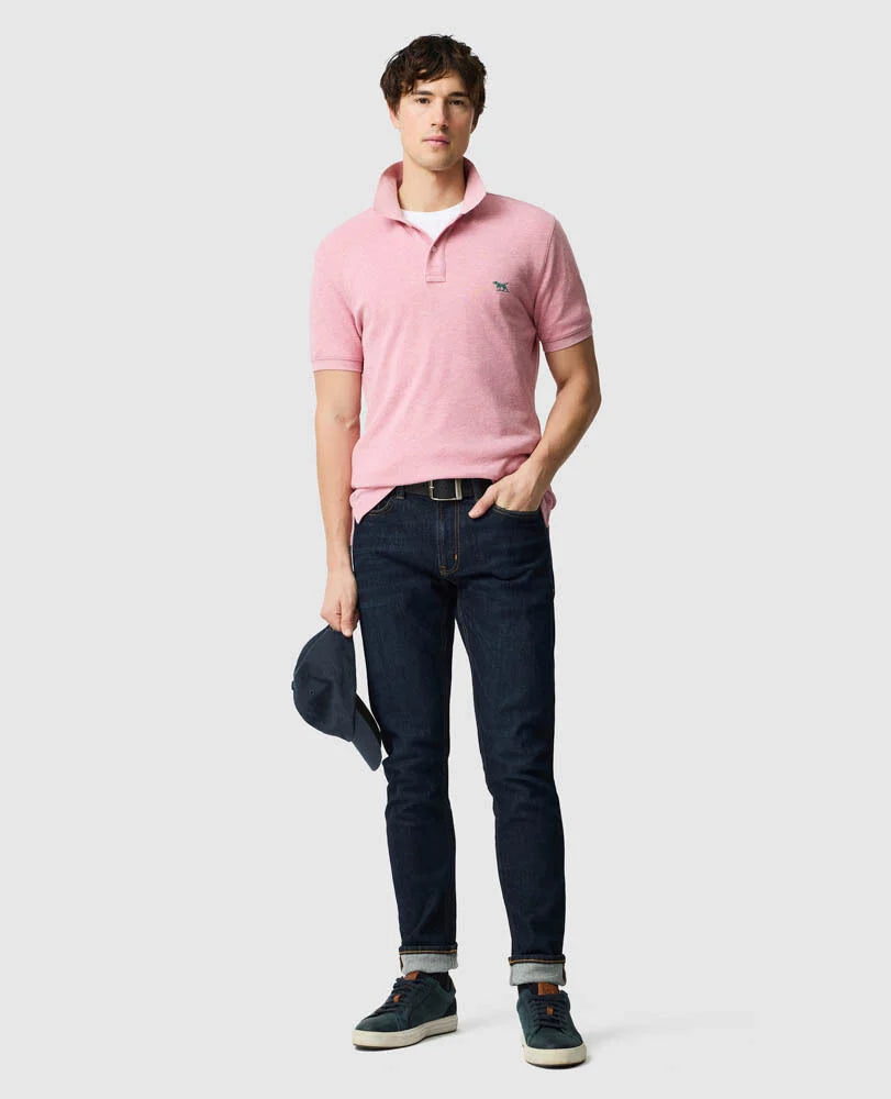 Rodd & Gunn - The Gunn Polo - Coral - MULTIBUY worn by a model with denim jeans and a hat, showcasing casual style.