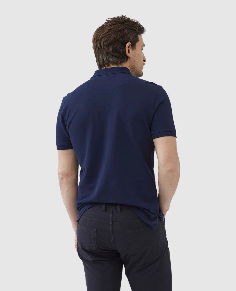 Rodd & Gunn - The Gunn Polo - Eclipse - MULTIBUY worn by a man from the back, showcasing the navy pique fabric.