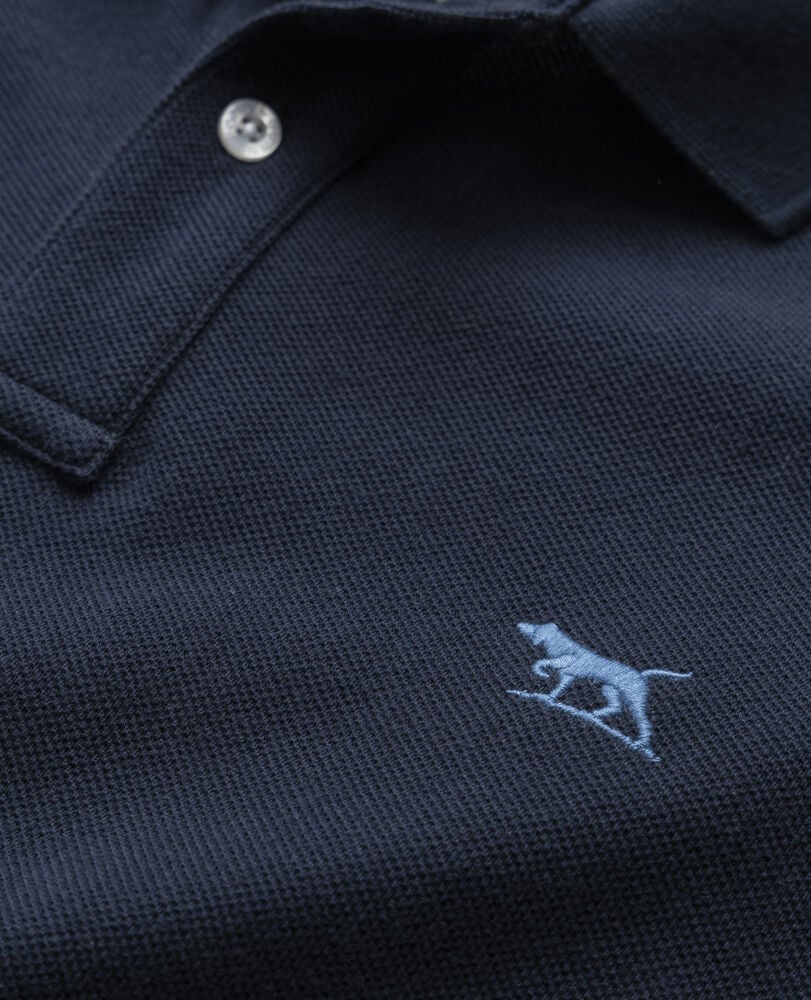 Rodd & Gunn - The Gunn Polo - Eclipse - MULTIBUY close-up showing navy pique fabric and embroidered dog logo.