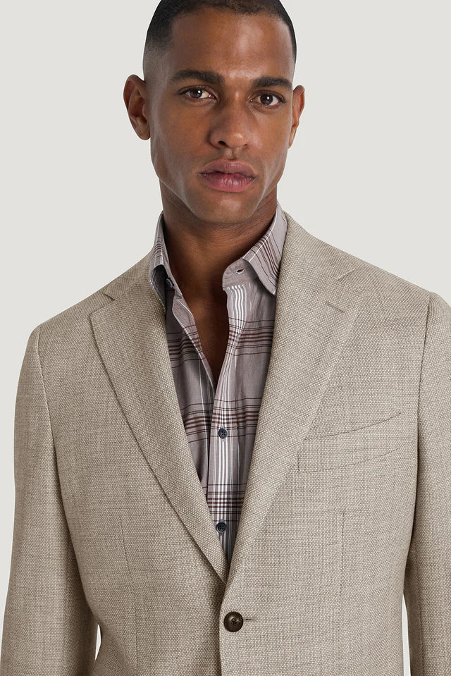 M.J.Bale - Hailwood Jacket - Light Brown worn by a model featuring a plaid shirt and light brown textured fabric.
