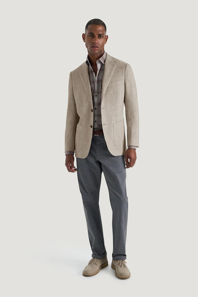 M.J.Bale - Hailwood Jacket - Light Brown worn by a model, showcasing a sophisticated look with stylish gray trousers.
