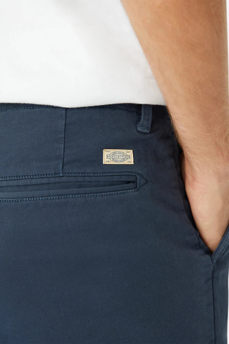 Navy blue pants with a brand label on a white background