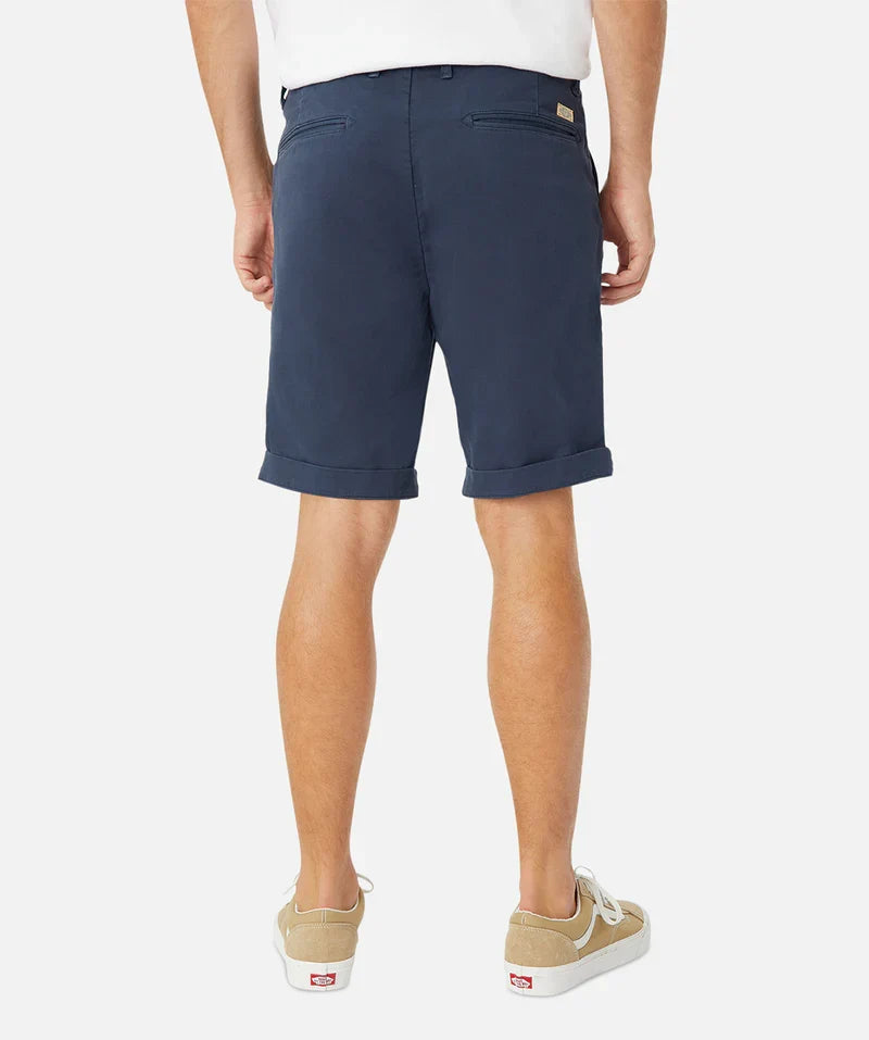 Person wearing navy shorts on a white background