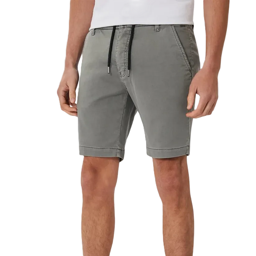 A person wearing gray drawstring shorts with a white shirt, shown from the chest down against a plain white studio background.
