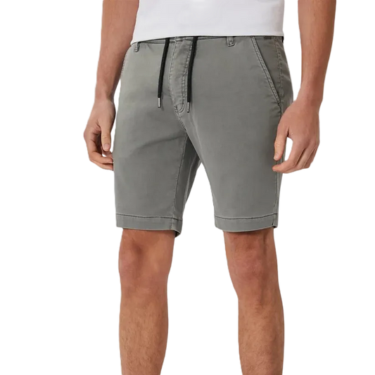 A person wearing gray drawstring shorts with a white shirt, shown from the chest down against a plain white studio background.