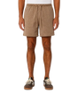 A person wearing tan corduroy drawstring shorts, shown from the waist down against a plain light gray studio background.