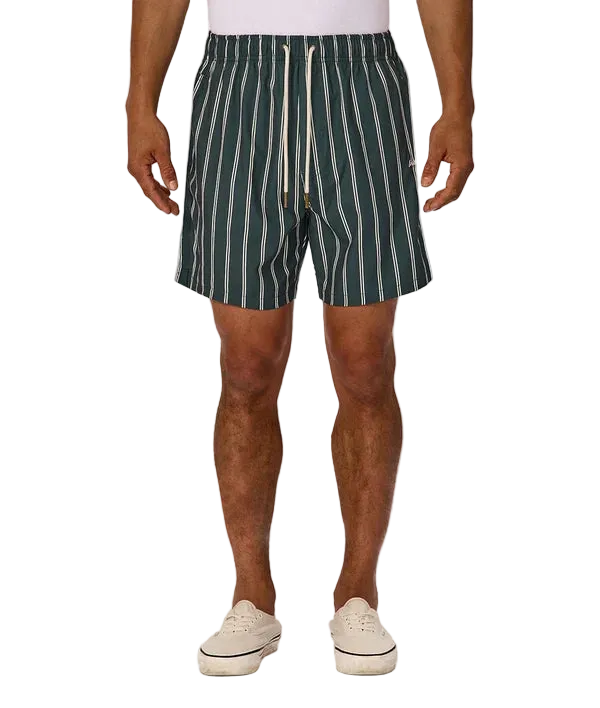 A man wearing dark green and white vertically striped drawstring shorts, paired with a white t-shirt and off-white sneakers, shown from the waist down on a light gray background.