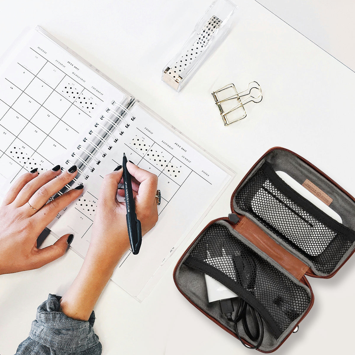 Jekyll and Hide - Compact Zip Around Cable Pouch - Tan | Black | Mocha organized with tech accessories on a desk.