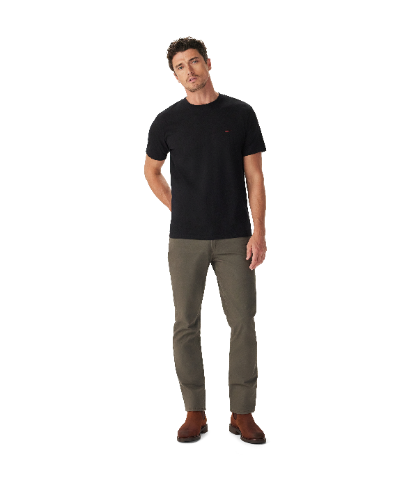 Man wearing a black t-shirt and green pants on a white background